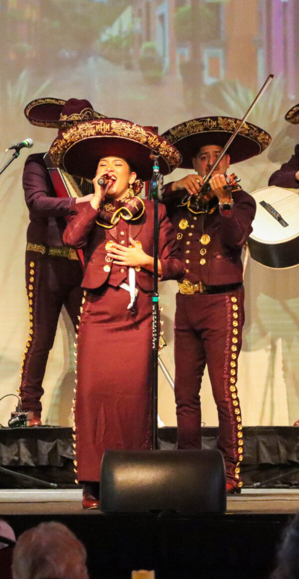 Color photo of four mariachi musicians performing onstage.