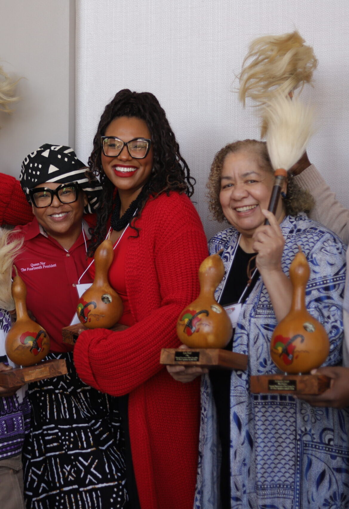 Three Black Appalachian Storytellers Fellows pose with their awards and cowtail switches.