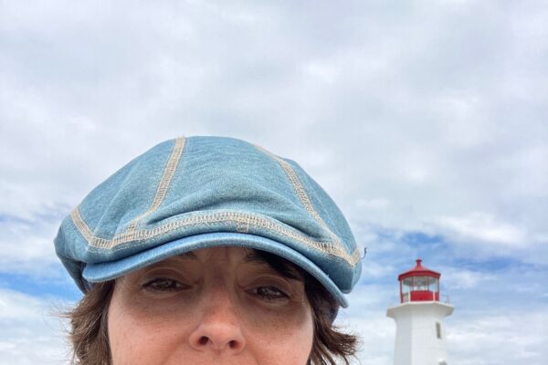 Headshot of paulA neves on a beach with a blue sky in the background.