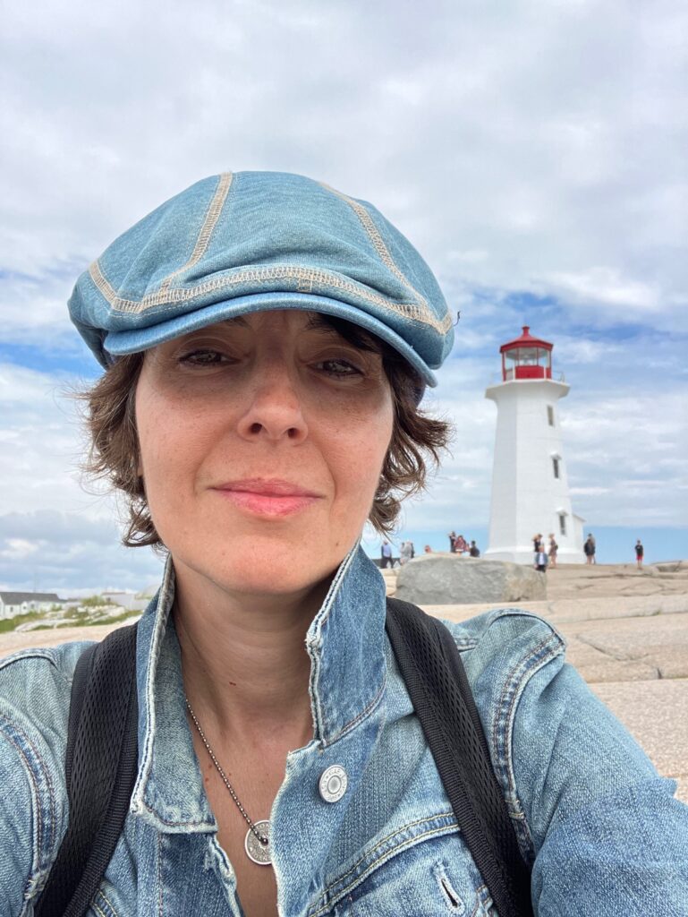 Headshot of paulA neves on a beach with a blue sky in the background.