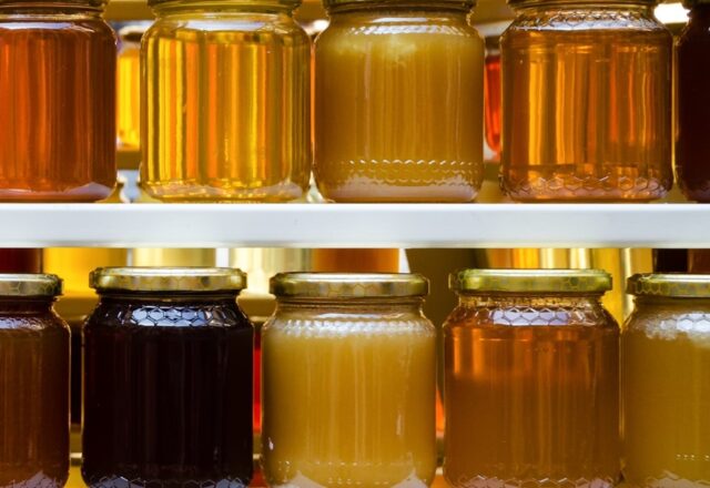 Shelves of jars of honey.