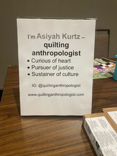 Information signage about quiltmaker Asiyah Kurtz.