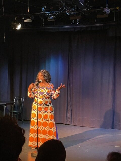 Michelle Washington presents at a standing microphone.