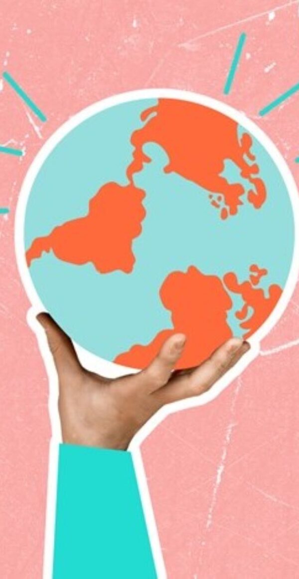 A hand holds a globe above.