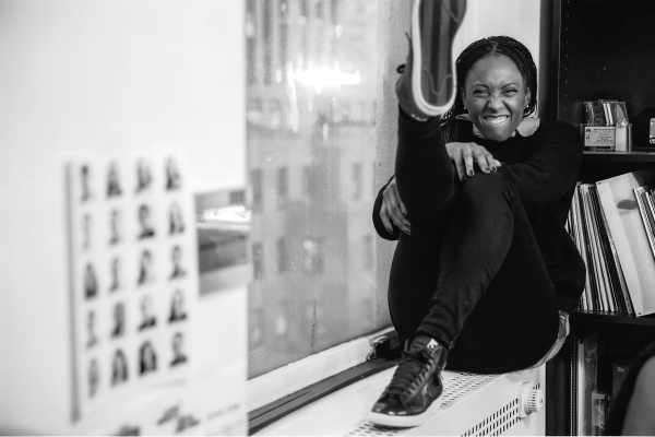 Black and white image of Michele Byrd-McPhee on an interior window sill.